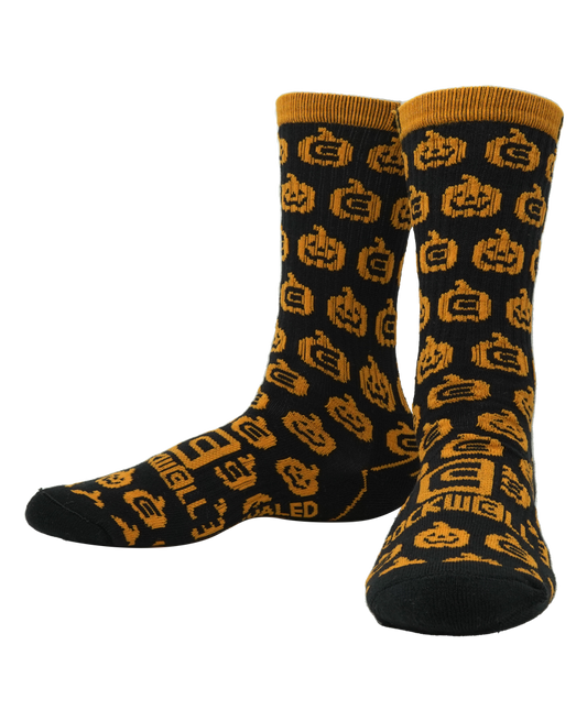 Rockwell halloween socks. orange pumpkins on black sock